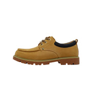 A single tan suede lace-up shoe shown in side profile on a light gray background. The shoe has tan laces, a black collar lining, and a brown lug sole.