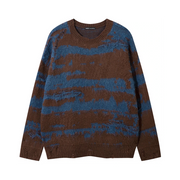 A long-sleeve crewneck knit sweater with a distressed, abstract pattern of horizontal brown and blue stripes, photographed flat on a white background.