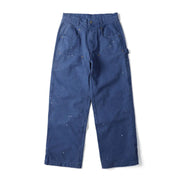 A pair of dark blue canvas work pants with white paint splatters, shown flat against a white background.