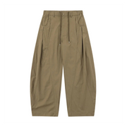 A pair of wide-leg, pleated trousers in a muted khaki or olive-tan color, shown flat against a solid white background.