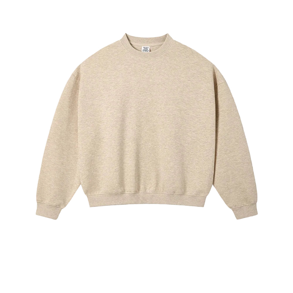 A light beige crewneck sweatshirt laid flat against a textured off-white background, with the text 'HAZE GOLD' printed below it.