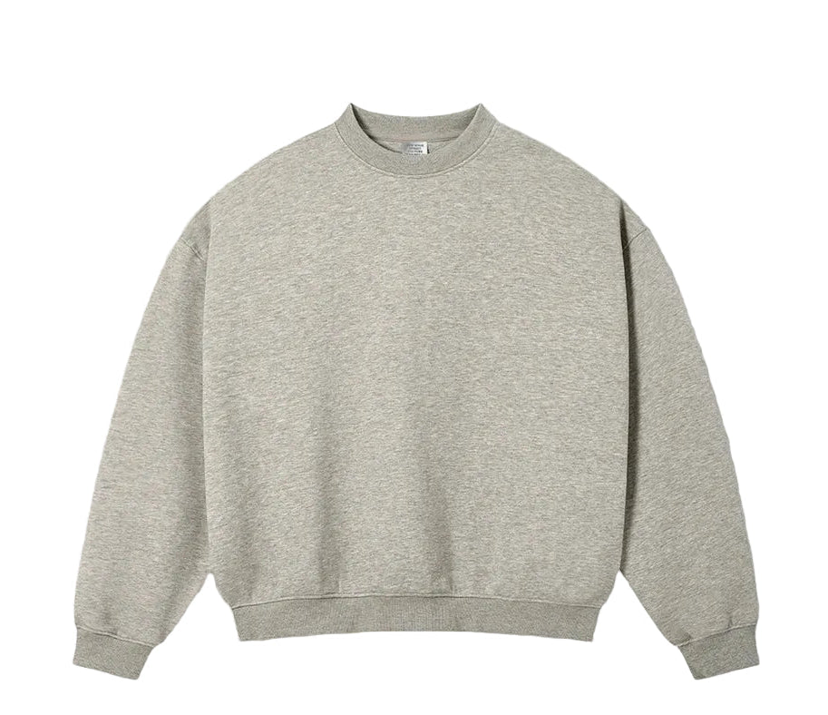 A light oat grey crewneck sweatshirt laid flat against a textured off-white background, with 'OAT GREY' text printed below it.