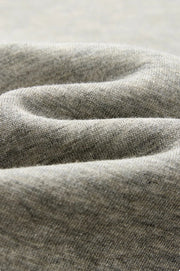 Close-up of draped gray fabric with a soft, textured weave and Chinese text below describing the material.