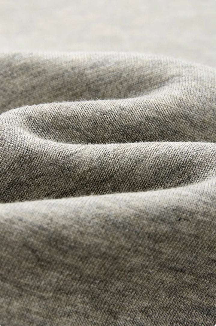 Close-up of draped gray fabric with a soft, textured weave and Chinese text below describing the material.