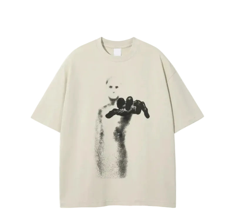 A beige short-sleeve t-shirt featuring a black graphic print of a maskless figure holding a black object, displayed against a solid white background.