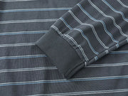 Close-up of a dark gray ribbed knit fabric with thin white and light blue horizontal stripes, showing a folded cuff detail.
