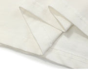 Close-up of white fabric with a subtle pattern on a white background