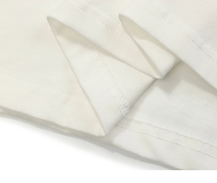 Close-up of white fabric with a subtle pattern on a white background