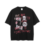 A black short-sleeve graphic t-shirt featuring a distressed red and white text print and collage-style face graphics on the front, displayed against a solid white background.