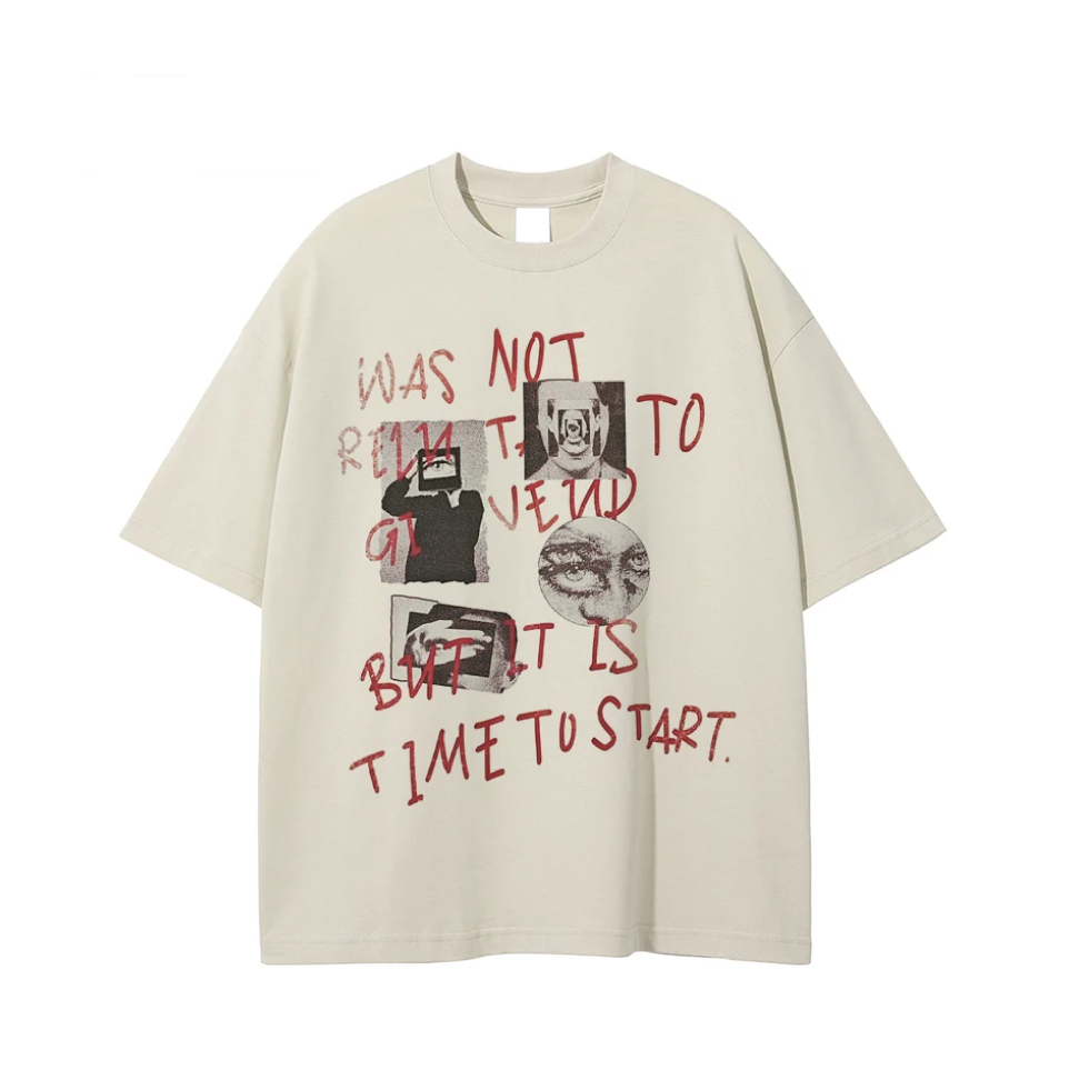 An oversized cream-colored t-shirt with a graphic print featuring red handwritten text and black-and-white images, displayed flat against a white background.