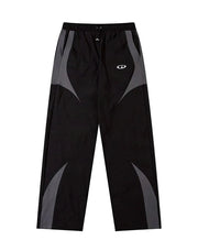 Black and gray athletic pants with a white logo on the left thigh, displayed on a white background.